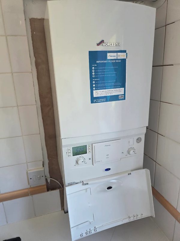 Worcester Bosch combi boiler with the service flap open showing the controls and display